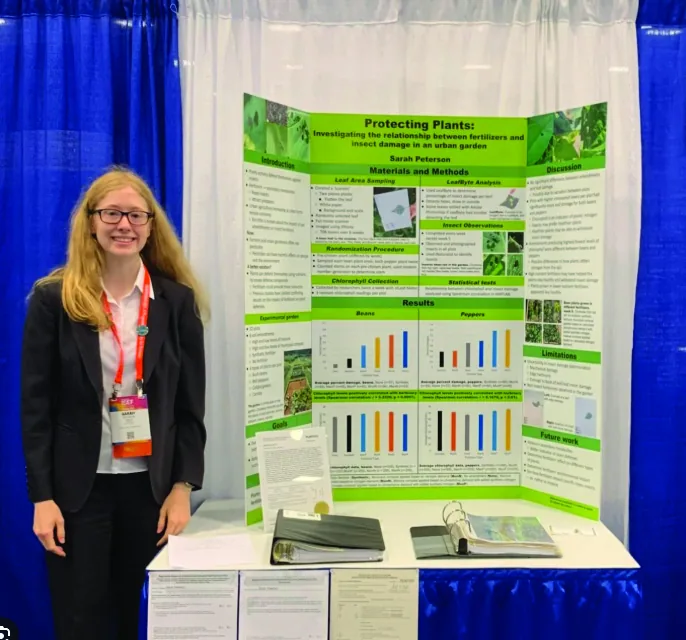Student presenting plant research at a science fair