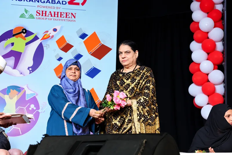 Women Presenting Roses on Ceremony Stage